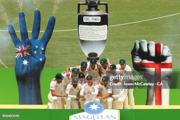 The Australian team celebrate winning the Ashes series with the Ashes trophy and replica Urn during day five of the Fifth Test match in the 2017/18...