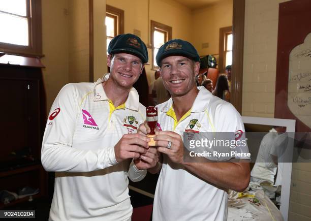Steve Smith and David Warner of Australia celebrate with the Ashes Urn in the change rooms during day five of the Fifth Test match in the 2017/18...