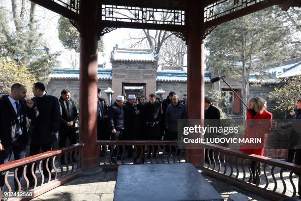 French President Emmanuel Macron and his wife Brigitte Macron are given a tour during a visit to the Great Mosque of Xian in the northern Chinese...