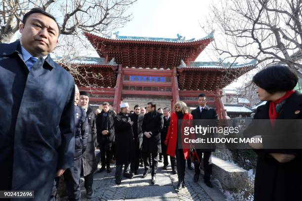 French President Emmanuel Macron and his wife Brigitte Macron are given a tour during a visit to the Great Mosque of Xian in the northern Chinese...