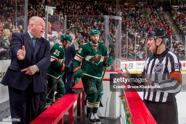 Minnesota Wild head coach Bruce Boudreau and referee Brad Watson talk during the game against the Nashville Predators at the Xcel Energy Center on...