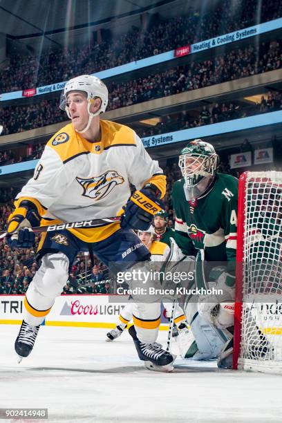 Devan Dubnyk of the Minnesota Wild defends against Kyle Turris of the Nashville Predators during the game at the Xcel Energy Center on December 29,...