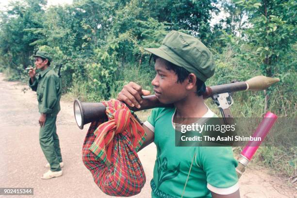 Young Pol Pot soldier carrying a rocket launcher is seen on November 8, 1992 in Kampong Speu, Cambodia.