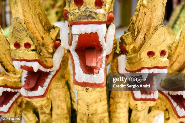the naga serpents on the entrance of the temple of the phra bang buddha - divinità foto e immagini stock