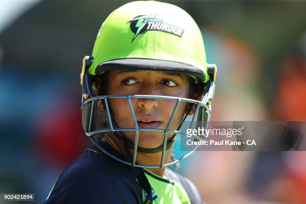 Harmanpreet Kaur of the Thunder looks on while waiting to bat during the Women's Big Bash League match between the Perth Scorchers and the Sydney...