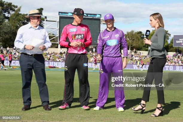 Johan Botha of the Sydney Sixers and George Bailey of the Hobart Hurricanes complete the coin toss during the Big Bash League match between the...