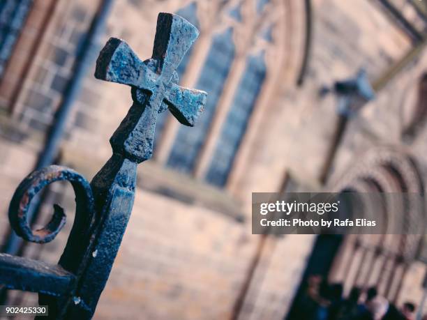 iron cross at the gate of the church - anglican stock pictures, royalty-free photos & images