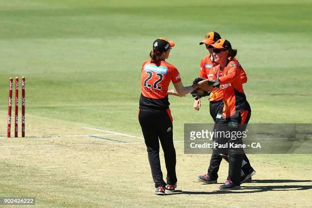 Emily Smith and Lauren Ebsary of the Scorchers celebrate the run-out of Harmanpreet Kaur of the Thunder during the Women's Big Bash League match...