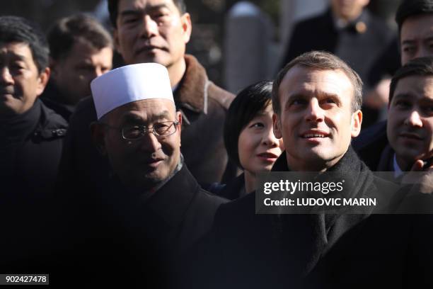 French President Emmanuel Macron is given a tour during a visit to the Great Mosque of Xian in the northern Chinese city of Xian on January 8, 2018....