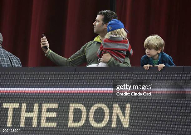 Donald Trump Jr. Takes a photo above a marquee displaying the name of a bull, THE DON, competing during the 2018 Professional Bull Riders Monster...