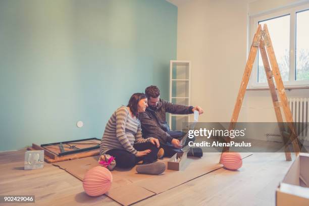 pregnant couple in a new home - prepare stock pictures, royalty-free photos & images