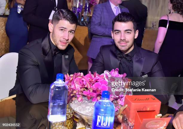 Singer Nick Jonas and Joe Jonas attend FIJI Water at HFPAs Official Viewing and After-Party at the Wilshire Garden inside The Beverly Hilton on...
