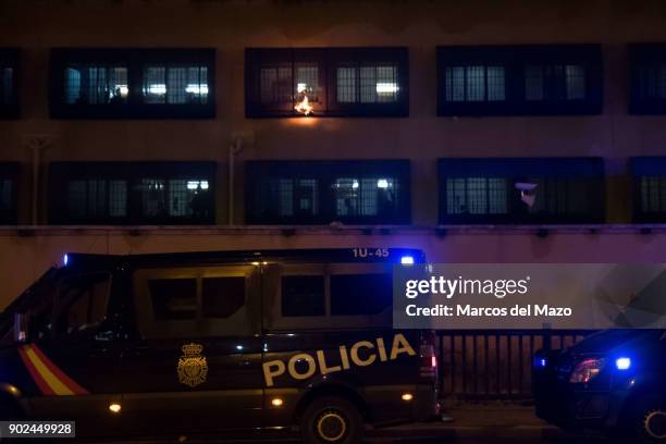 Migrants inside Aluche CIE burning papers in the windows as a demonstration arrives to demand the closure of detention centers after the last dead...