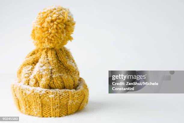 snow-covered knit hat - knit hat stock pictures, royalty-free photos & images