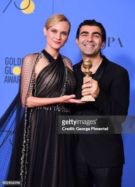 Director Fatih Akin , winner of the award for Best Motion Picture for 'In the Fade,' and actor Diane Kruger pose in the press room during The 75th...