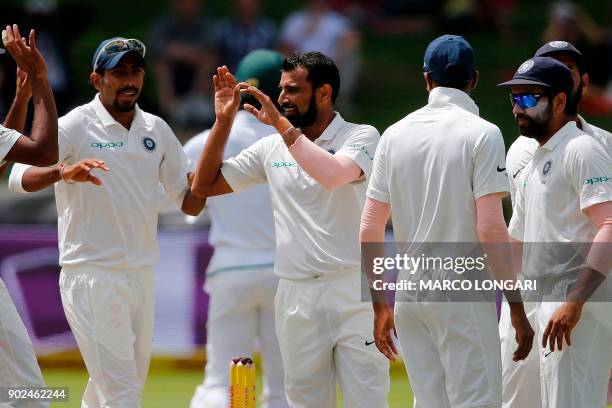 Indian bowler Mohammed Shami celebrates with teammates after the dismissal of South African batsman Kagiso Rabada during the fourth day of the first...