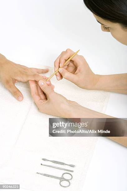 woman using a cuticle pusher to give a manicure - nail scissors - fotografias e filmes do acervo