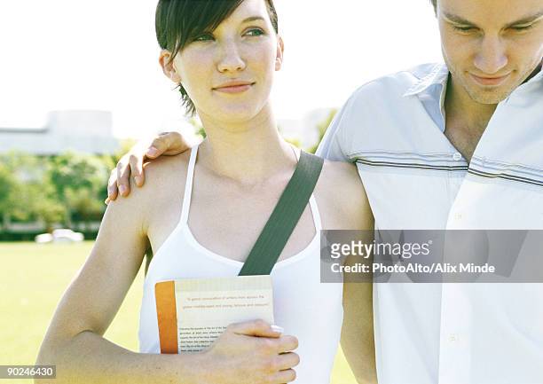 young couple, man's arm around woman's shoulder - summer university day 2 foto e immagini stock