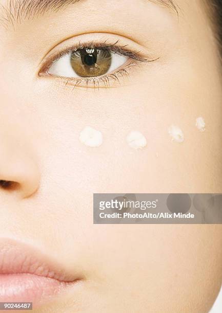 woman's face with concealer under eye, close-up - concealer stock pictures, royalty-free photos & images