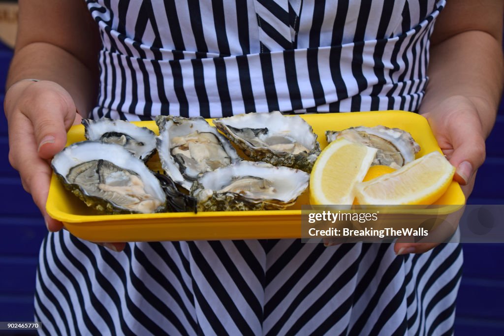 Midsection Of Woman Holding Seafood