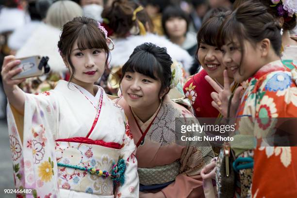 Japanese women wearing kimonos take selfie pictures during their Coming of Age Day celebration ceremony at Tokyo, January 08 Japan. The Coming of Age...
