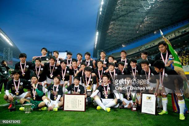 Players of Maebashi Ikuei celebrate for victory with trophy after the 96th All Japan High School Soccer Tournament final match between Ryutsu Keizai...