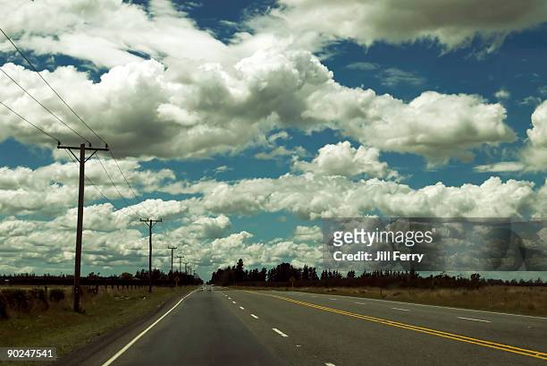view up a long straight highway - canterbury plains stock pictures, royalty-free photos & images