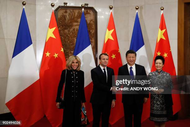 French President Emmanuel Macron and his wife Brigitte Macron meet with Chinese President Xi Jinping and his wife Peng Liyuan before a meeting at the...