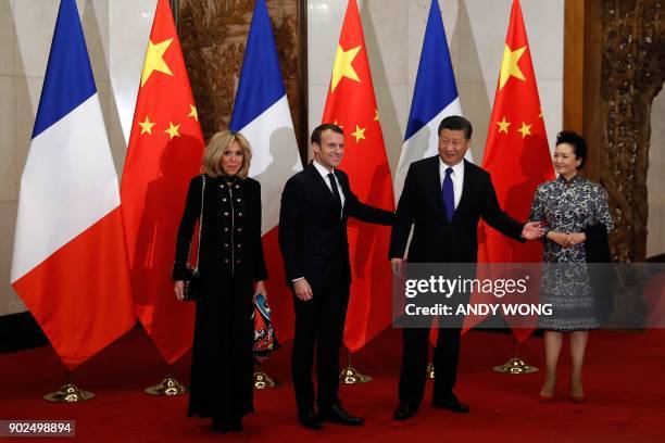 French President Emmanuel Macron and his wife Brigitte Macron meet with Chinese President Xi Jinping and his wife Peng Liyuan before a meeting at the...