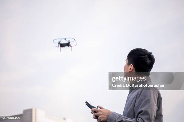 men operate drones - radio controlled handset stock pictures, royalty-free photos & images