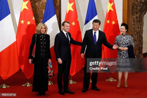 French President Emmanuel Macron, second from left, and wife Brigitte Macron, left, meet with Chinese President Xi Jinping, second from right, and...