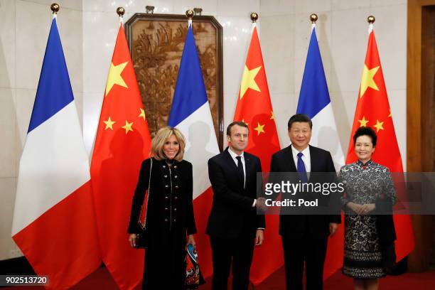 French President Emmanuel Macron, second from left, and wife Brigitte Macron, left, meet with Chinese President Xi Jinping, second from right, and...