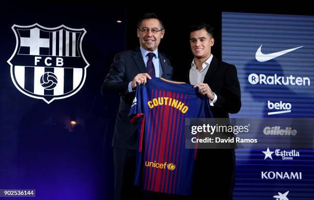 New Barcelona signing Philippe Coutinho and Josep Maria Bartomeu, President of Barcelona pose with his shirt at Camp Nou on January 8, 2018 in...