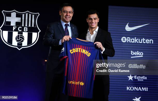 New Barcelona signing Philippe Coutinho and Josep Maria Bartomeu, President of Barcelona pose with his shirt at Camp Nou on January 8, 2018 in...
