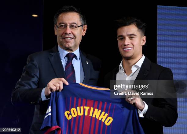 New Barcelona signing Philippe Coutinho and Josep Maria Bartomeu, President of Barcelona pose with his shirt at Camp Nou on January 8, 2018 in...