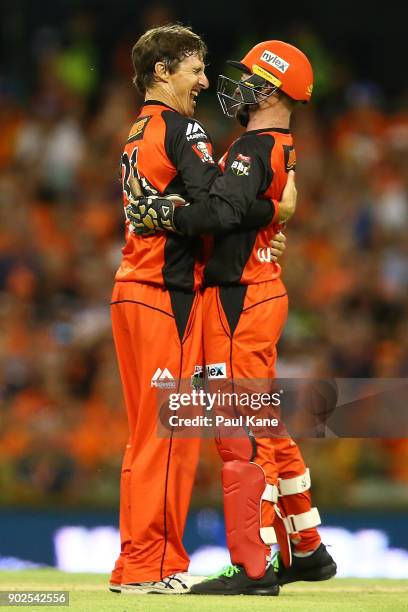 Brad Hogg and Tim Ludeman of the Renegades celebrate the wicket of Hilton Cartwright of the Scorchers during the Big Bash League match between the...