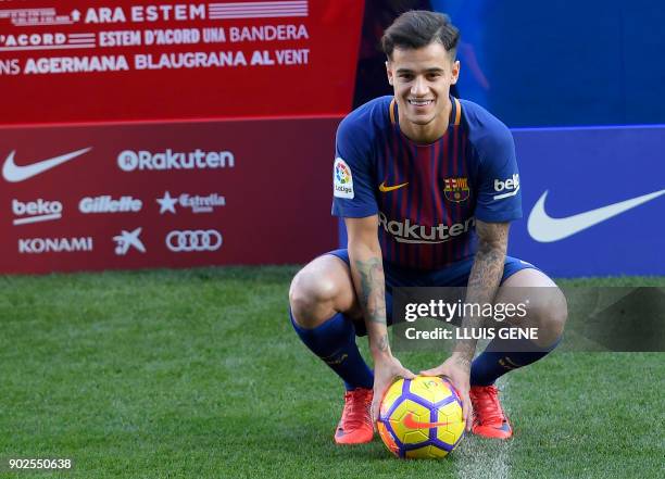 Barcelona's new Brazilian midfielder Philippe Coutinho poses with his new jersey during his official presentation in Barcelona on January 8, 2018....