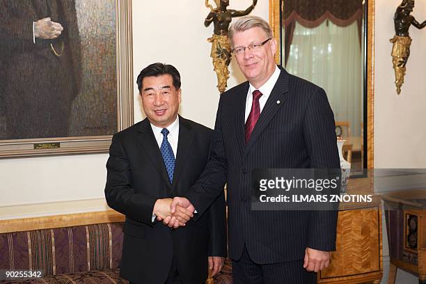 China's Vice Prime Minister Hui Liangyu and Latvian President Valdis Zatlers shake hands prior to a meeting in Riga on September 1, 2009. Hui Liangyu...