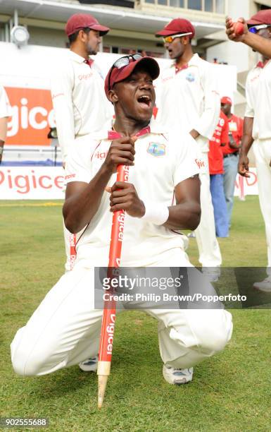 Jerome Taylor of West Indies celebrates with a souvenir stump after the 1st Test match between West Indies and England at Sabina Park, Kingston,...