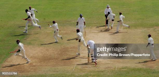 Sulieman Benn of West Indies runs off the field with two stumps after taking the final England wicket of Steve Harmison, bowled for 0, to win the 1st...