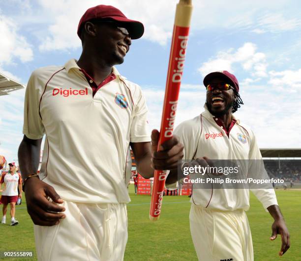 Sulieman Benn of West Indies and team captain Chris Gayle celebrate with a lap of honour after West Indies win the 1st Test match between West Indies...