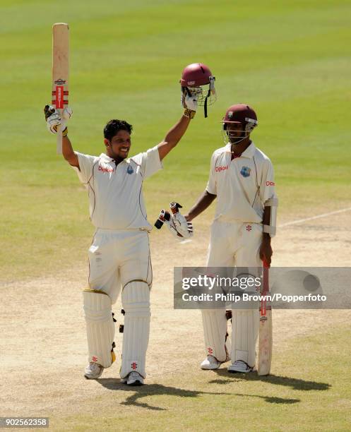 West Indies batsman Ramnaresh Sarwan celebrates reaching 200 runs during his innings of 291 with team mate Denesh Ramdin during the 4th Test match...