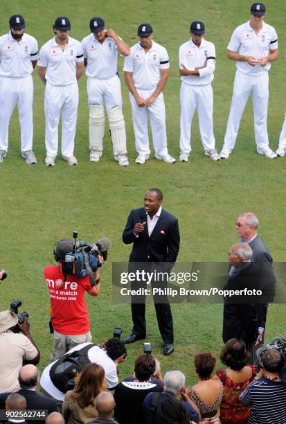 England players look on as former West Indies cricketer Brian Lara speaks to the crowd during the opening of the Brian Lara Pavilion at Queen's Park...