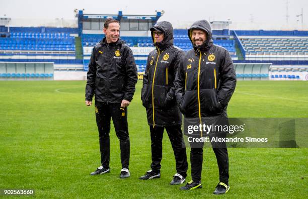 Peter Stoeger, head coach of Borussia Dortmund, and his assistant coaches Joerg Heinrich and Manfred Schmid during a rainy training session as part...