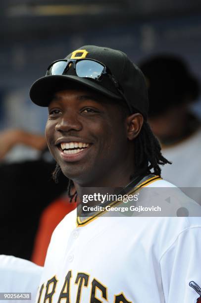 Outfielder Lastings Milledge of the Pittsburgh Pirates smiles as he looks on from the dugout before a Major League Baseball game against the Arizona...