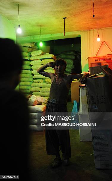 An Afghan man finishes his work day in time for iftar, the breaking of the fast, during the holy month of Ramadan in Kabul on September 1, 2009....