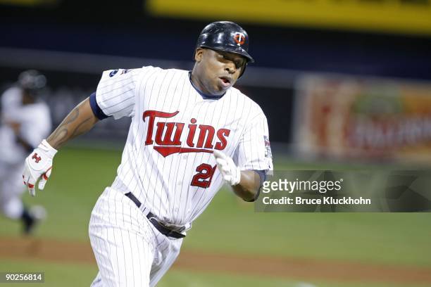 Delmon Young of the Minnesota Twins rounds third on his way to score against the Baltimore Orioles on August 25, 2009 at the Metrodome in...