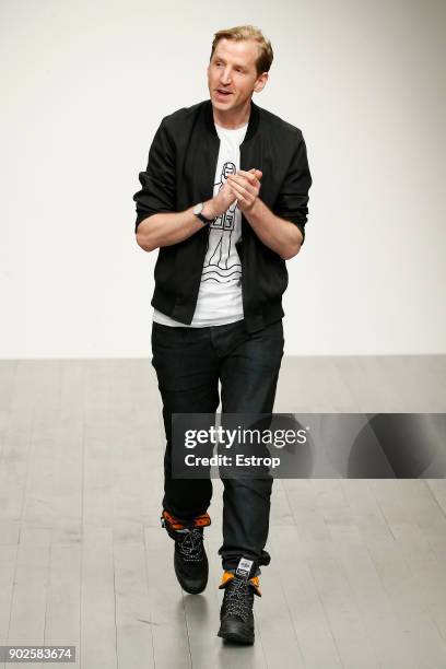 Model walks the runway at the Christopher Raeburn show during London Fashion Week Men's January 2018 at BFC Show Space on January 7, 2018 in London,...