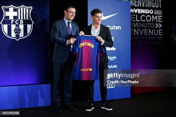 New Barcelona signing Philippe Coutinho and Josep Maria Bartomeu, President of Barcelona pose with his shirt at Camp Nou on January 8, 2018 in...