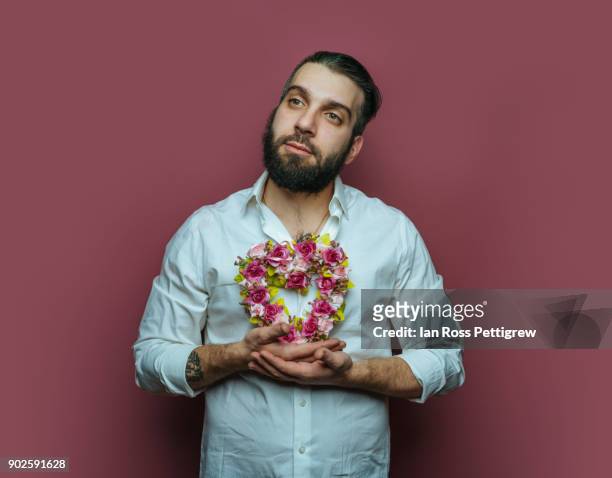 Man holding small heart wreath